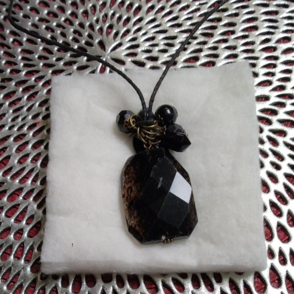 Necklace,Brown stone on cord.